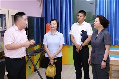 圖③：“小公民法律課堂”開講前，全國人大代表殷其龍（右二）、重慶市人大代表李自玲（左二）聽取楊家坪中學(xué)負責(zé)人關(guān)于未成年人思想教育工作情況的介紹。