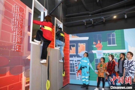 5月9日，留學生體驗模擬高樓緩降逃生。張鷹 攝