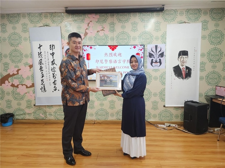 警察語言學院老師與王大昕交換禮品?；顒又鬓k方供圖