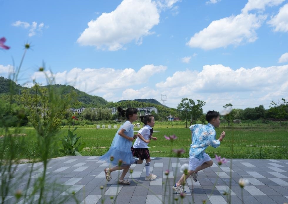 兒童在余姚市梁弄鎮(zhèn)的田野間奔跑（7月3日攝）。新華社記者翁忻旸 攝