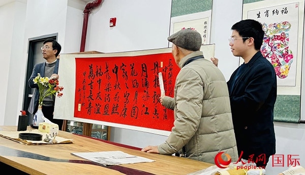 旅秘書法家向現(xiàn)場觀眾展示書法作品。人民網(wǎng)記者 宋亦然攝