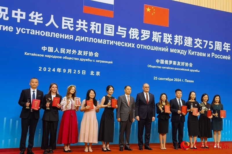 楊萬明會(huì)長和莫爾古洛夫大使為10位中俄青年友好微視頻創(chuàng)意大賽獲獎(jiǎng)代表頒獎(jiǎng)。人民網(wǎng)記者 李明琪攝