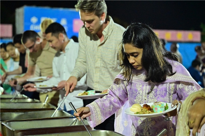 外國(guó)友人品嘗中國(guó)美食。馬騫攝
