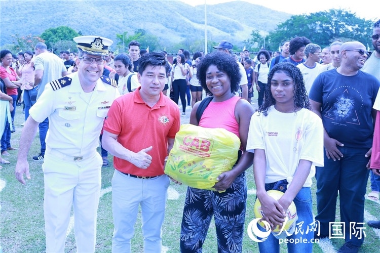 巴西中國浙江商會會長鄭俠茂向巴西貧困社區(qū)兒童及家庭捐贈基礎(chǔ)食品籃子和足球。人民網(wǎng)記者陳海琪 攝