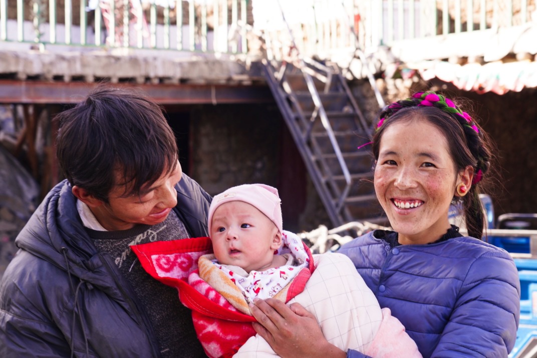 1月11日，在西藏日喀則市人民醫(yī)院，受災(zāi)群眾抱著自己在地震中受傷的孩子康復(fù)出院。人民日?qǐng)?bào)記者徐馭堯攝