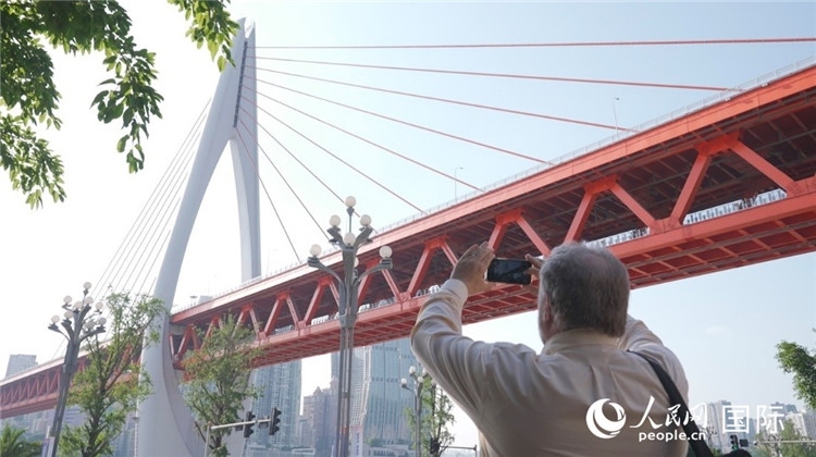 軻寶華“打卡”重慶東水門長江大橋。人民網(wǎng)記者 蘇纓翔攝
