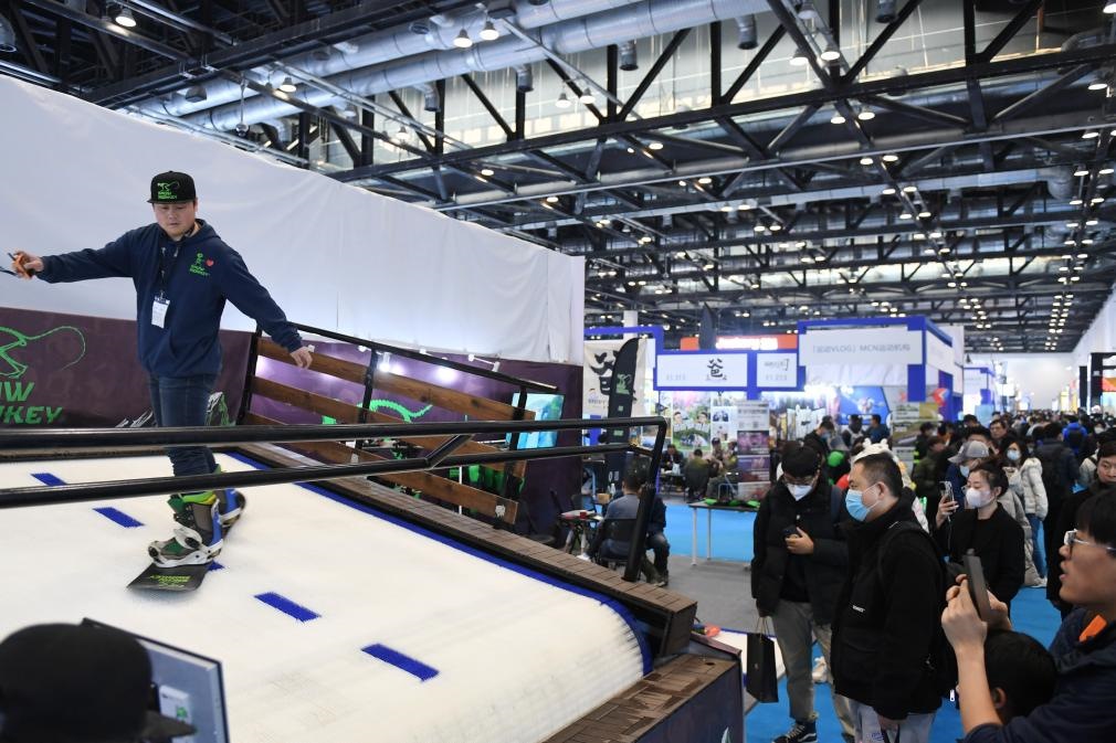 2023年2月11日，參觀者在展會上了解一款模擬滑雪設(shè)備。當(dāng)日，2023亞洲運動用品與時尚展在國家會議中心拉開帷幕。新華社記者 張晨霖 攝