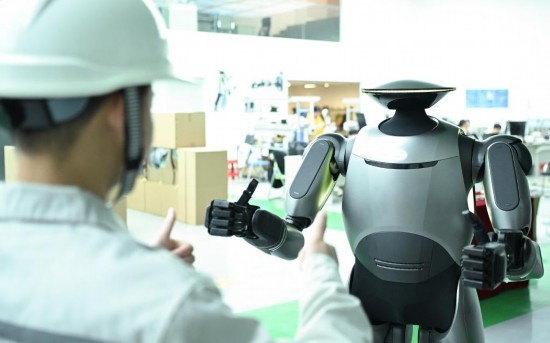 在廣汽研究院，人形機(jī)器人團(tuán)隊的周仁義在演示GoMate機(jī)器人互動功能（新華社記者 鄧華 攝）